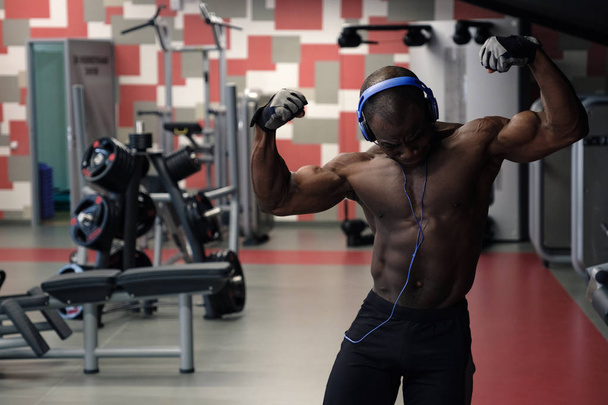 Bodybuilder man posing in the gym - 写真・画像
