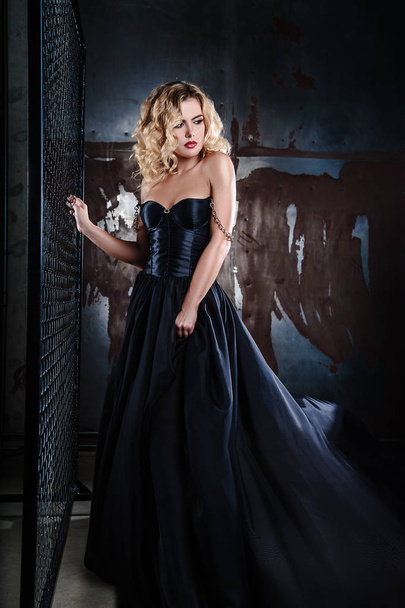portrait of young sexy blonde woman in a black dress - Fotoğraf, Görsel