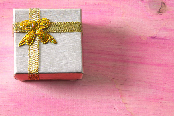 Christmas card with label, gift box and Christmas balls on pink background - Valokuva, kuva