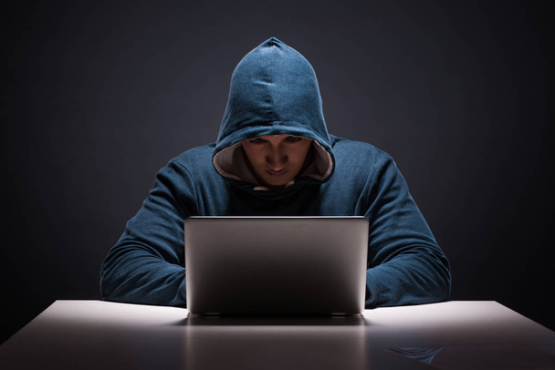 Computer hacker working in dark room - Фото, зображення
