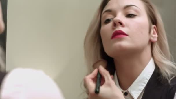 Woman in front of mirror putting make up on - Séquence, vidéo