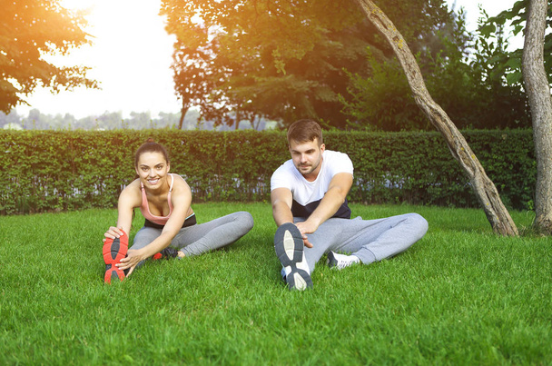 Happy sporty young couple training outdoors - Foto, afbeelding