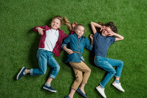 Children lying on grass  - Foto, Imagen
