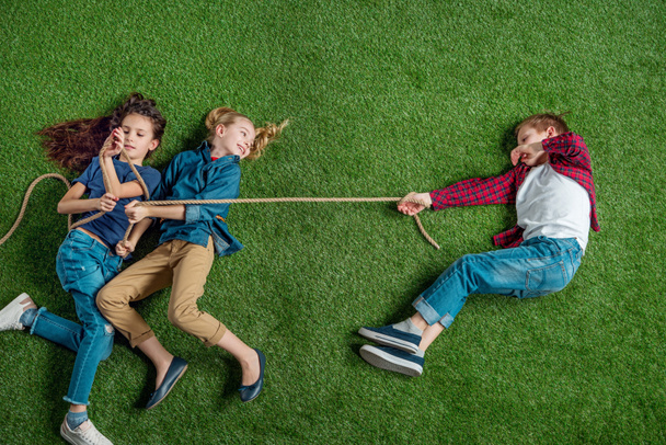 Children playing tug of war  - Fotó, kép