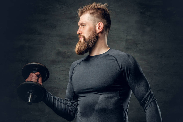 Sporty bearded man holds dumbbell - Foto, Imagem