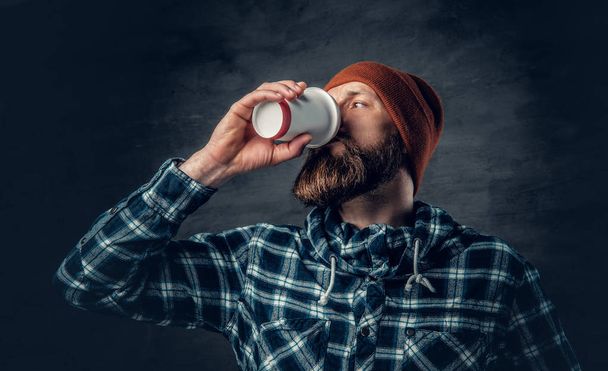 Man drinks coffee from a paper cup - Photo, Image
