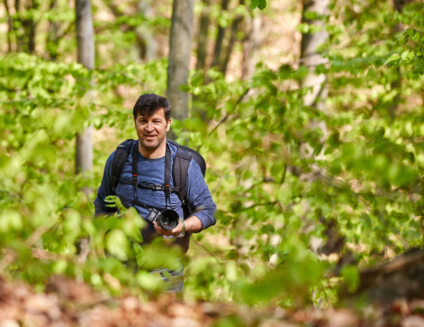 Tourist with backpack in forest - Zdjęcie, obraz