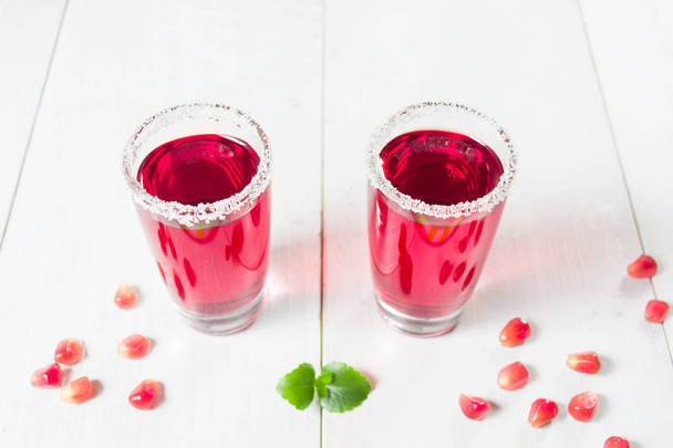 Two red pomegranate  beverages with sugar decoration - Photo, image