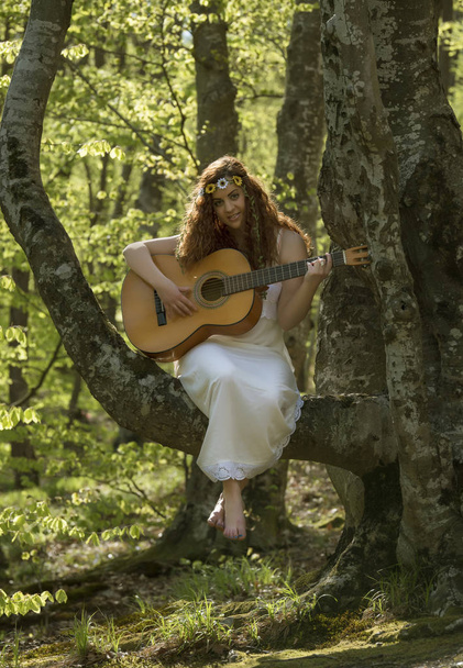 Girl with red hair playing guitar - Fotó, kép