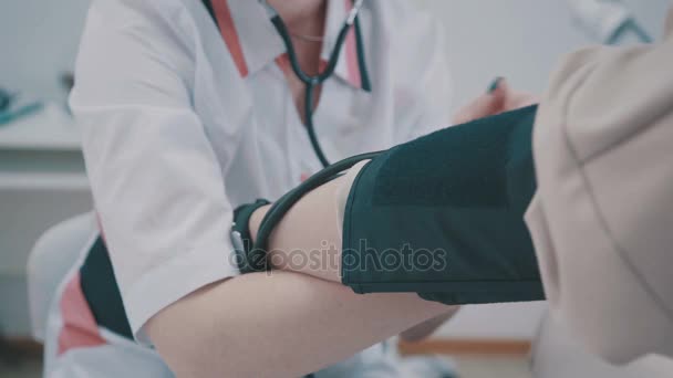 Blood pressure measuring. Doctor and patient. Health care. - Materiaali, video