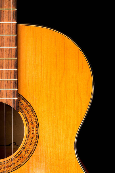 The old classical guitar   on black  background. - 写真・画像