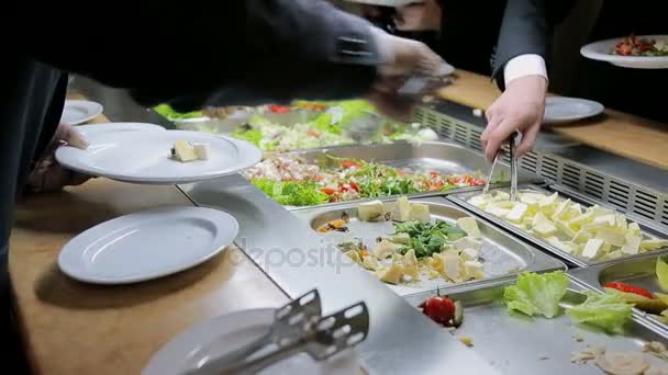 People impose food. Catering. Impose Salad. Food Distribution Table. - Footage, Video