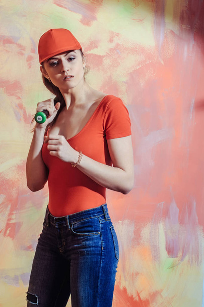 Pretty girl in red cap with green bat - 写真・画像