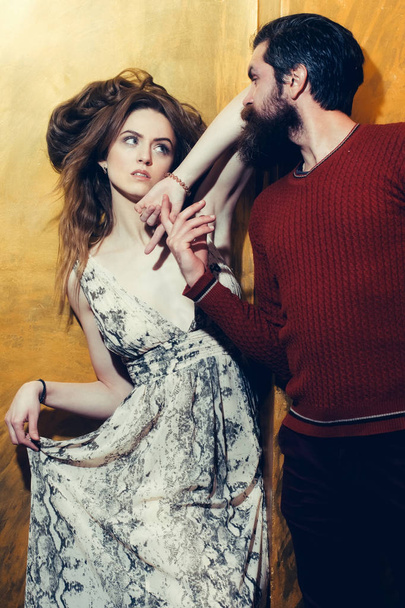 Pretty girl and bearded man with beard holding hands - 写真・画像