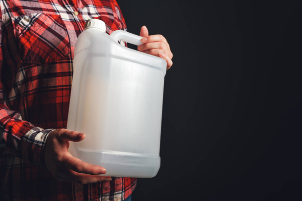 White plastic tank canister in female hand - Foto, immagini