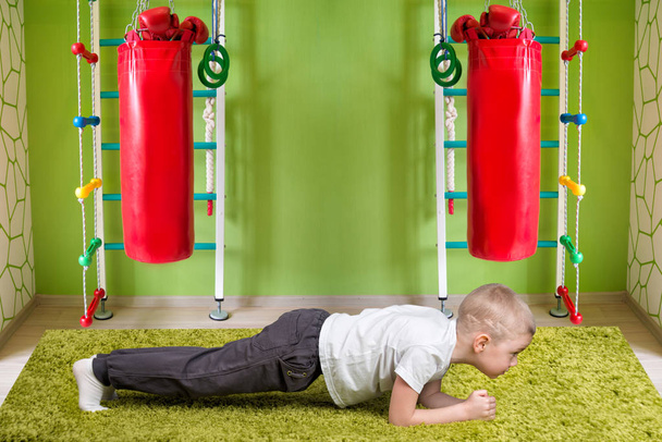 Baby boy doing strength exercise perfect plank .Physical education,fitness,sports.concept of a healthy lifestyle. - Φωτογραφία, εικόνα