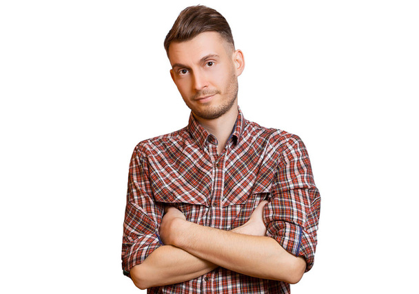 Young european guy in plaid shirt posing with his hands crossed  - Zdjęcie, obraz