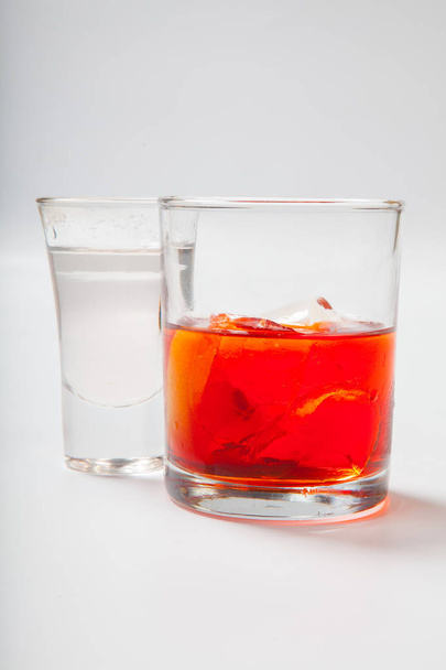 Vodka and a cocktail on a white background - Фото, изображение