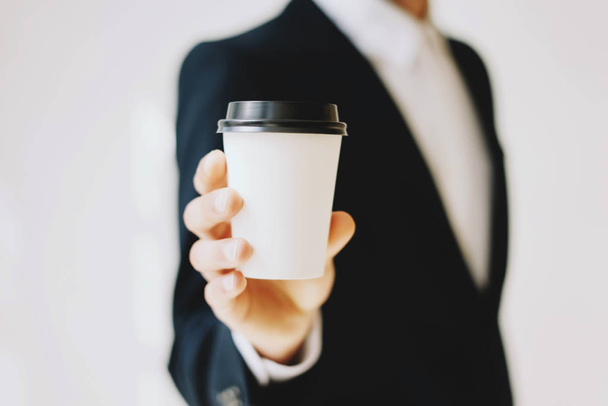 Businessman holding coffee cup  - Фото, зображення