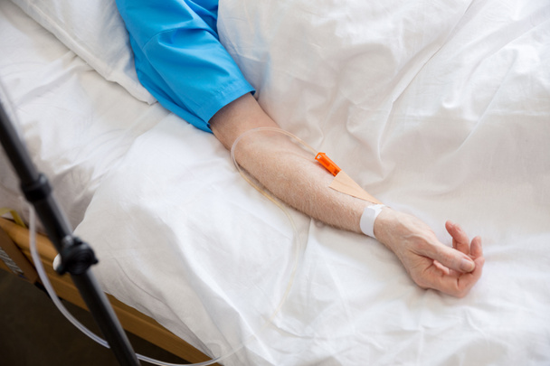 Senior man in hospital bed  - Фото, изображение