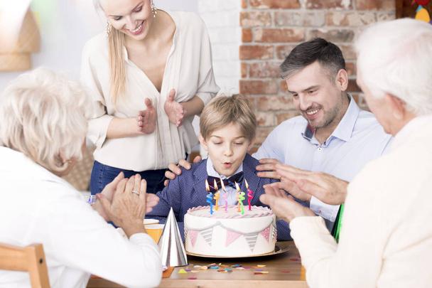 Boy blowing out candles - Foto, imagen