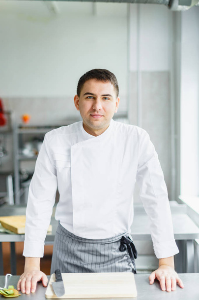 Young smiling male chef posing - Photo, Image