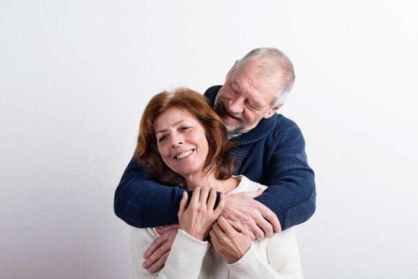 Beautiful senior couple in love hugging. Studio shot. - Zdjęcie, obraz