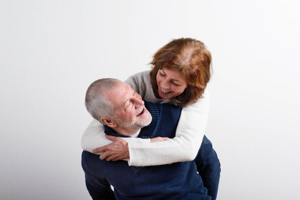 Beautiful senior couple in love hugging. Studio shot. - Φωτογραφία, εικόνα