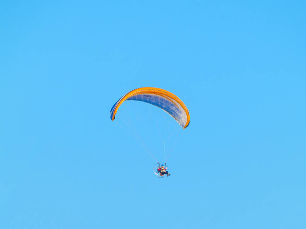 A man practicing extreme sport with paraglider with motor - Foto, imagen