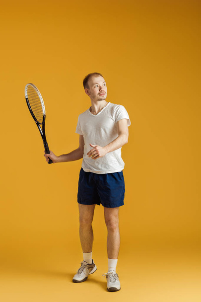 young tennis player plays tennis on yellow background - Photo, image