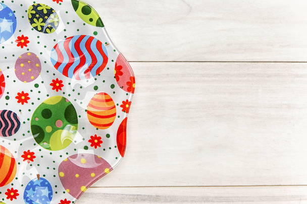 Easter chocolate egg with colorful explosion of candies and sweets on gray colored wooden background. - Photo, image