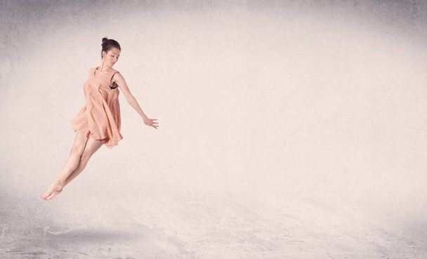 Modern ballet dancer performing art jump with empty background - Foto, Bild