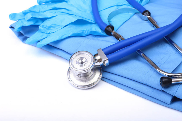 Medical stethoscope, Gloves, RX prescription on blue doctor uniform closeup. Medical tools and instruments shop, blood pressure measurement concept - Фото, изображение