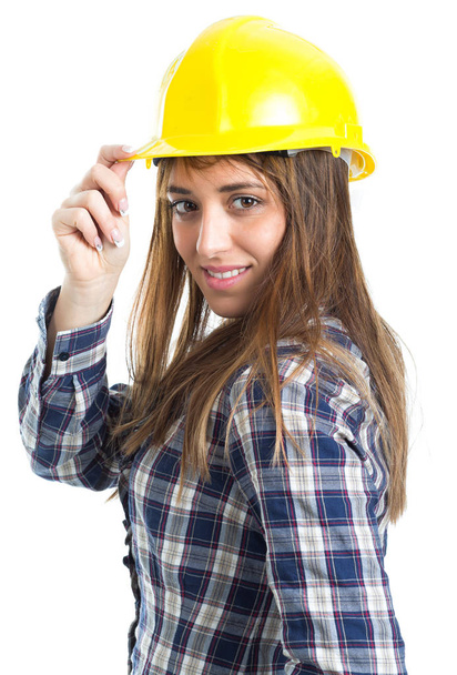 Aantrekkelijke jonge vrouw bouwer met helm en werk handschoen. Geïsoleerd op witte achtergrond. - Foto, afbeelding
