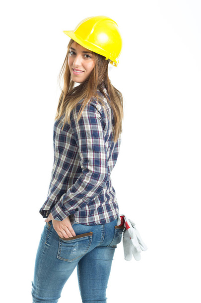 attraktive junge Bauarbeiterin mit Helm und Arbeitshandschuh. isoliert auf weißem Hintergrund. - Foto, Bild