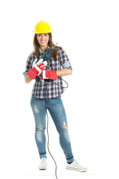 Attractive young woman builder with drill tool happy for good work. Isolated on white background. - Photo, Image