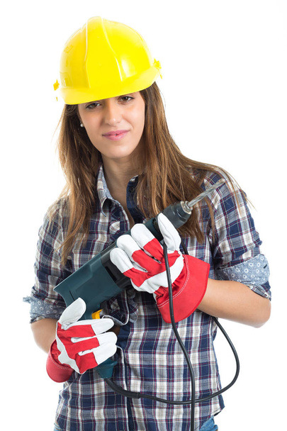 Attractive young woman builder with drill tool happy for good work. Isolated on white background. - Photo, Image