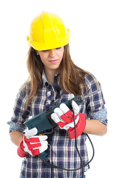 Attractive young woman builder with drill tool happy for good work. Isolated on white background. - Foto, Imagem
