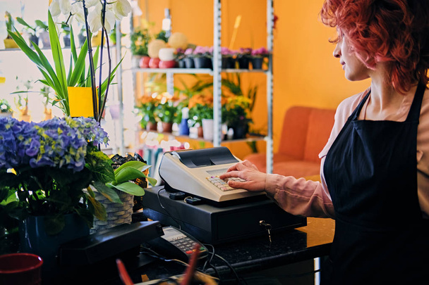 Female flower seller using cash register - Photo, Image