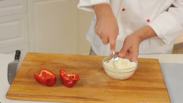 Cooking peppers stuffed with cheese - Filmmaterial, Video