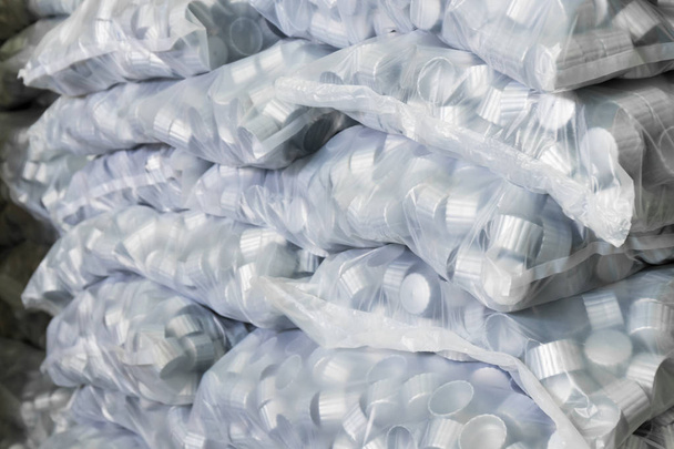 gray plastic bottle caps in plastic bag - Photo, Image