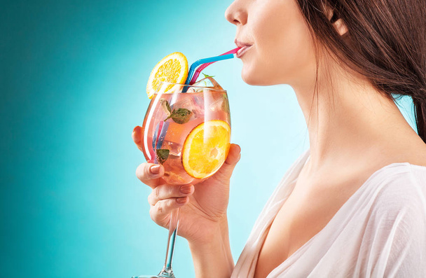 The pretty woman drinking cocktail. Emotion. Hairstyle. - Foto, Imagen