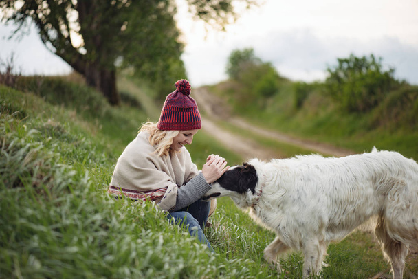 Girl playing with her dog outdoors - Photo, Image