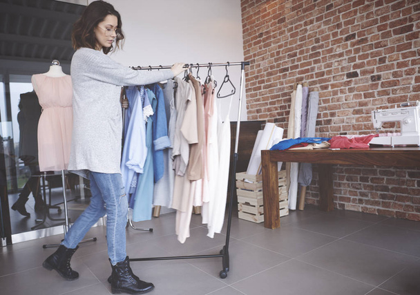 Fashion designer walking with clothes rail  - Photo, Image