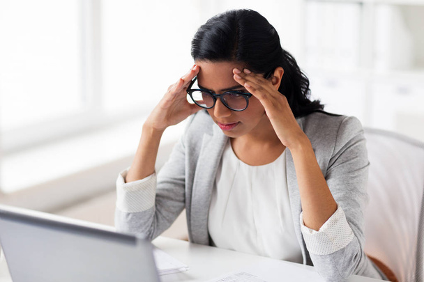 stressed businesswoman with laptop at office - Φωτογραφία, εικόνα