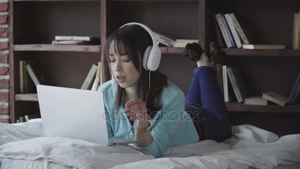 woman in headphones working on a laptop - Footage, Video