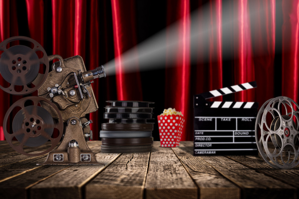 Cinema concept of vintage film reels, clapperboard and projector. - Foto, imagen