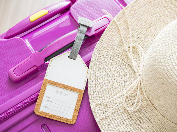 luggage tag and white hat on pink suitcase 1 - Photo, Image