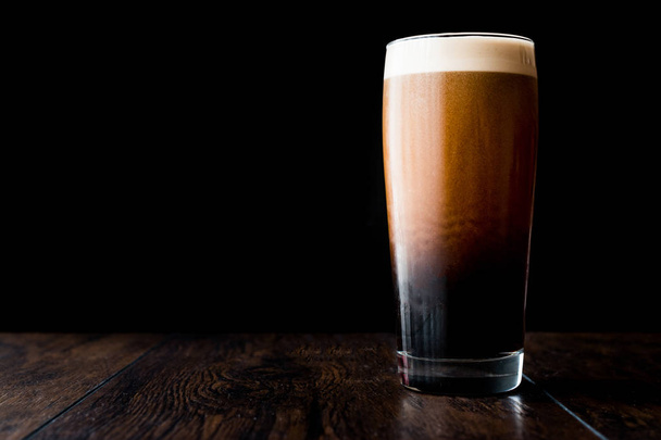 Dark beer on wooden surface. copy space. - Photo, image