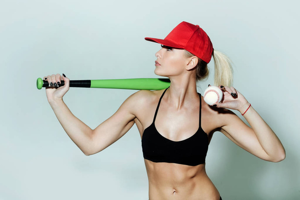 Pretty sporty girl athlete player holding green baseball bat, ball - Fotoğraf, Görsel